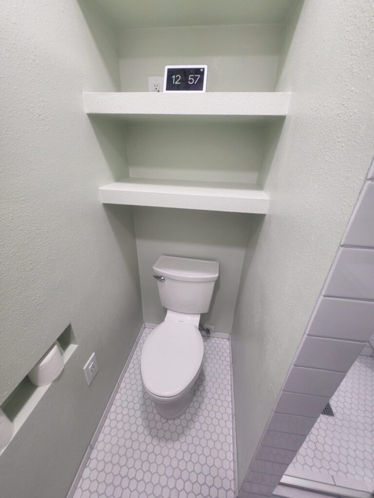 Built ins include tp niche, shelves, shower enclosure, shower seat, shoawer niche