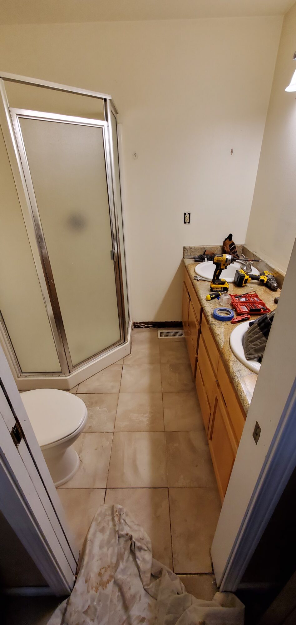 before pic, cramped shower, cracked tile from a flexing floor